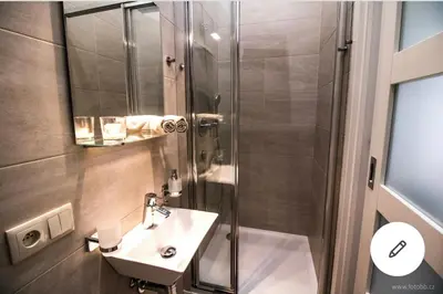 a bathroom with a shower and a sink at Romantic Apartment Petra - free parking Friday-Sunday in Prague