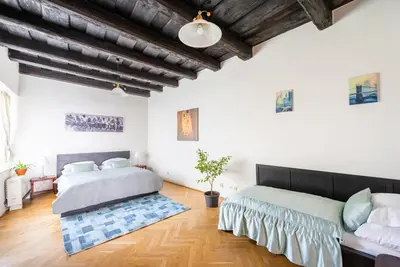 a walk in closet with a couch and a table at St. George Apartments in Prague