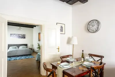a kitchen with wooden cabinets and a sink at St. George Apartments in Prague