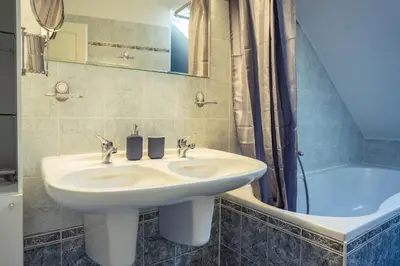 a bedroom with a bed and a lamp on a night stand at St. George Apartments in Prague