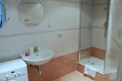 a bathroom with a sink and a shower at St. George Apartments in Prague