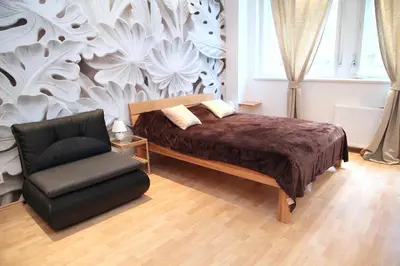 a bedroom with a bed and a chair at Old Town studio in Prague