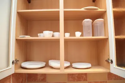a cabinet with plates and cups and dishes in it at Old Town studio in Prague