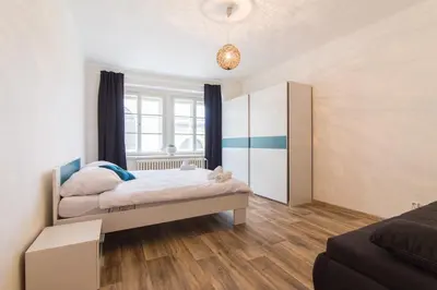 a bedroom with two beds and a window at Karlova Apartment in Prague