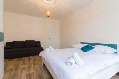 a bedroom with two beds and a couch at Karlova Apartment in Prague