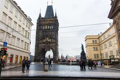 a tall tower in a city with people walking around at Karlova Apartment in Prague