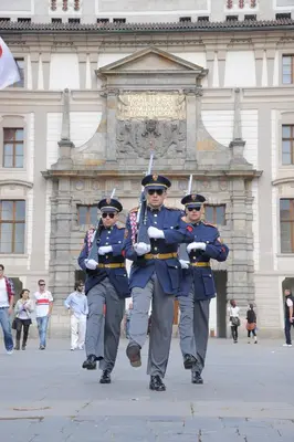 a group of men in uniform walking in front of a building at Karlova Apartment in Prague