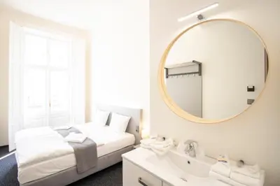 a bedroom with a bed and a mirror and a sink at Narodni Stay in Prague