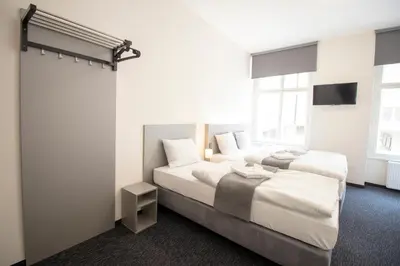 a hotel room with two beds and a tv at Narodni Stay in Prague