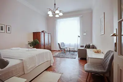 a bedroom with a bed and a living room at Apartment in the heart of Prague in Prague