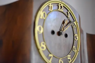 a gold clock is hanging on a wall at Apartment in the heart of Prague in Prague