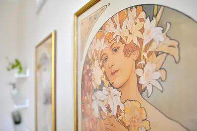 a painting of a woman with flowers on a wall at Apartment in the heart of Prague in Prague