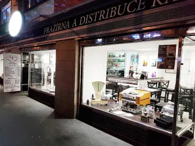 a store front with a display window of a furniture store at Yellow apartment few steps from metro in Prague