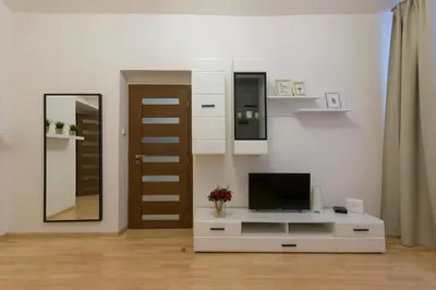 a living room with a television on a white cabinet at Spacious apartment near Wenceslas Square in Prague