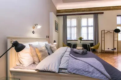 a bedroom with a large bed with pillows at Apartment Nebovidy I - Historic centre - Terrace - Air Conditioning in Prague