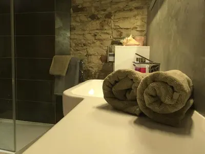 a bathroom with towels on the counter of a toilet at Apartment Nebovidy I - Historic centre - Terrace - Air Conditioning in Prague