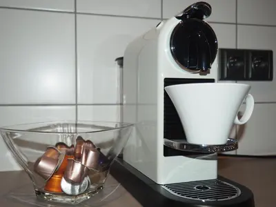 a coffee maker sitting on a counter next to a cup at Apartment Nebovidy I - Historic centre - Terrace - Air Conditioning in Prague