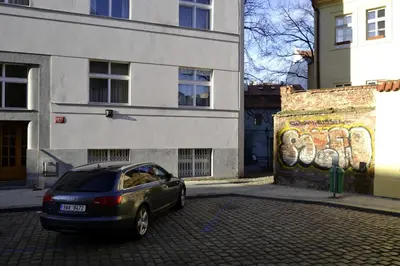 a car parked in a parking lot next to a building at Old Town Basement in Prague