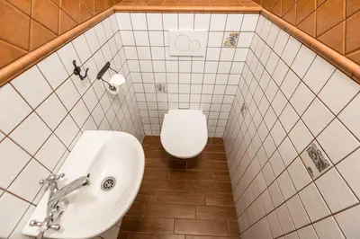a bathroom with a toilet and a sink at Mila Apartments in Prague