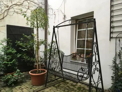 a balcony with a black iron gate and plants at Mila Apartments in Prague