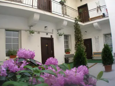a building with purple flowers in front of it at Mila Apartments in Prague