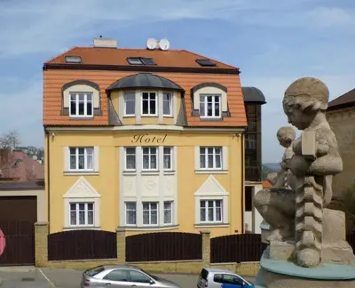 a yellow building in front of a building at Hotel Garni Rambousek in Prague