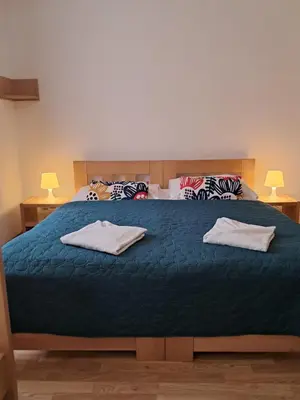 a bedroom with a large bed with two towels on it at Hotel Garni Rambousek in Prague