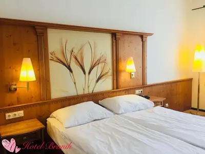 a bedroom with a large bed with two pillows at Hotel Braník in Prague
