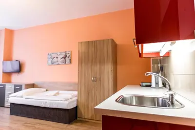 a kitchen with a sink and a bed at Rezidence Davids Apartments in Prague