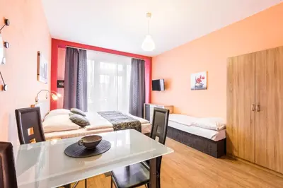 a hotel room with two beds and a table at Rezidence Davids Apartments in Prague