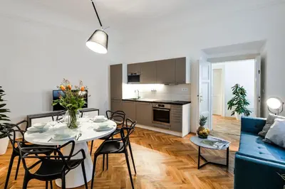 a living room with a table and a blue couch at Lazenska N4 Residence in Prague