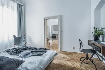 a bedroom with a bed and a desk and a mirror at Lazenska N4 Residence in Prague