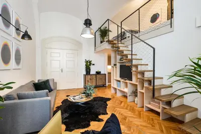 a living room with a staircase and a couch at Lazenska N4 Residence in Prague