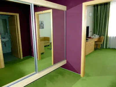 a room with purple walls and green floors at Hotel DAP in Prague