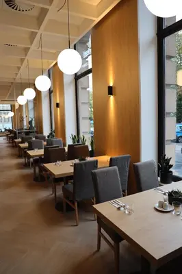 a row of tables and chairs in a restaurant at Hotel DAP in Prague