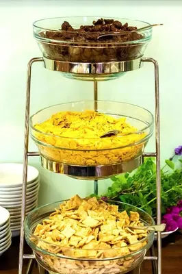 a three tiered serving rack with bowls of food at Hotel DAP in Prague