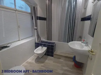 a bathroom with a sink and a toilet and a shower at DN Pub Apartments in Prague