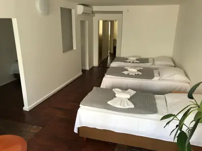 three beds in a room with white and gray at DN Pub Apartments in Prague