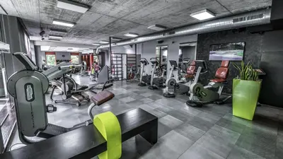 a gym with treadmills and elliptical machines at Volcano Spa Hotel in Prague