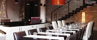 a row of tables and chairs in a restaurant at Volcano Spa Hotel in Prague
