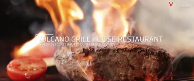 a close up of a fire with a piece of food at Volcano Spa Hotel in Prague