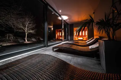 a bedroom with a bed and a large window at Volcano Spa Hotel in Prague