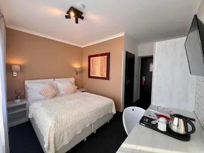 a hotel room with a bed and a table at Grand Petit Hotel ex Shato Gesson in Prague