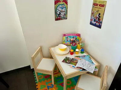 a small table with two chairs and a table with a book and a plate at Grand Petit Hotel ex Shato Gesson in Prague
