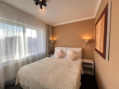 a bedroom with a white bed and a window at Grand Petit Hotel ex Shato Gesson in Prague