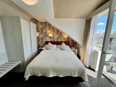 a bedroom with a large bed and a staircase at Grand Petit Hotel ex Shato Gesson in Prague