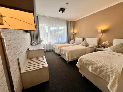 a hotel room with two beds and a window at Grand Petit Hotel ex Shato Gesson in Prague