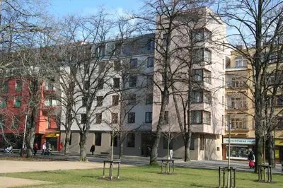 a large white building with trees in front of it at Lazensky Hotel Park in Poděbrady