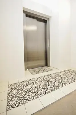 a hallway with a metal door and a carpet at Elizabeth Suites in Prague