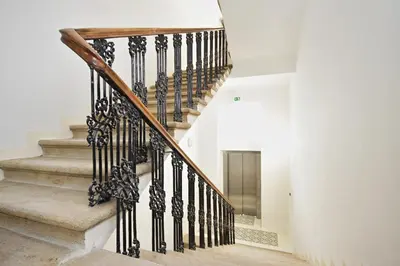 a staircase with black railings in a house at Elizabeth Suites in Prague